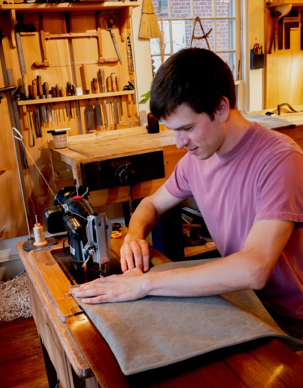 During the August 2024 Wiscasset Art Walk, Village Handcraft owner Eric McIntyre was sewing tote bags while engaging with visitors. BOB BOND/40 Federal Studio