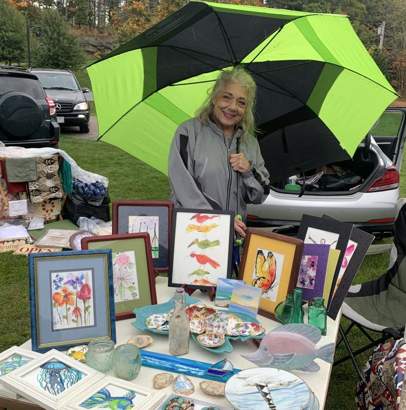 Volunteer Rosemarie Giordano displayed a beautiful collection of art during the yard sale. BILL PEARSON/Boothbay Register Rosemarie