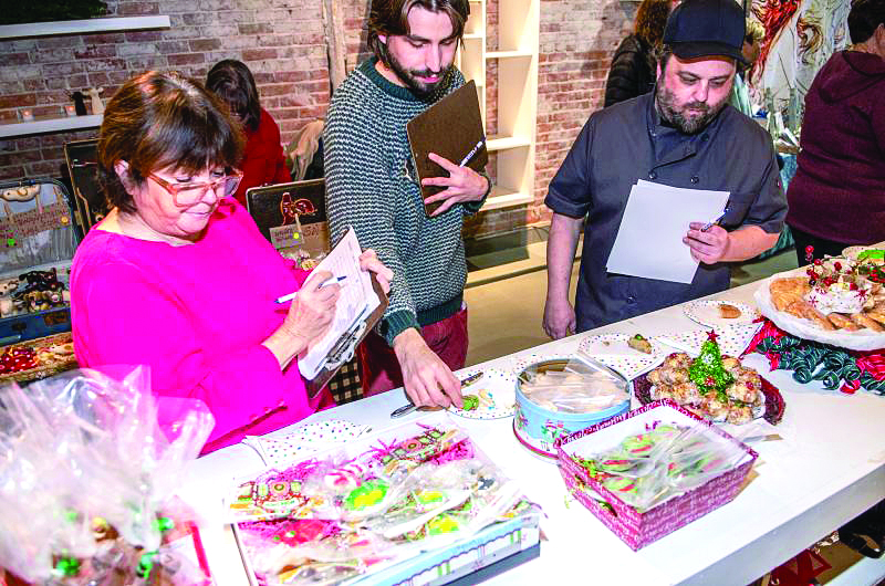 In 2023, Christmas Cookie Challenge judges, from left, Daphne Cromwell, Brad McCary and Anthony Weismann considered each cookie submission for appearance, texture, flavor, seasonality and presentation. Bob Bond photo Christmas Cookie Challenge