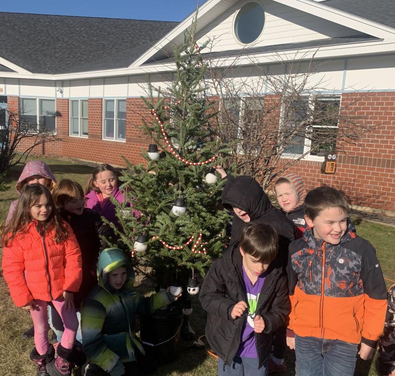Edgecomb second graders decorate their Christmas tree with snowmen sporting top hats and homemade garland Dec. 13 during the annual Edgecomb Charlie Brown Christmas Tree Decorating event. BILL PEARSON/Boothbay Register Edgecomb second graders