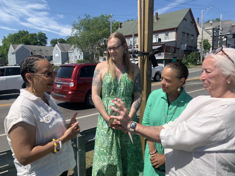 From left, Sonya Donaldson, assistant professor of African-American studies at Colby College in Waterville speaks as former Wiscasset selectman Heather Jones and State Sen. Rachel Talbot Ross look on and former selectman Terry Heller holds up her phone for those attending on Zoom. SUSAN JOHNS/Wiscasset Newspaper Ceremony