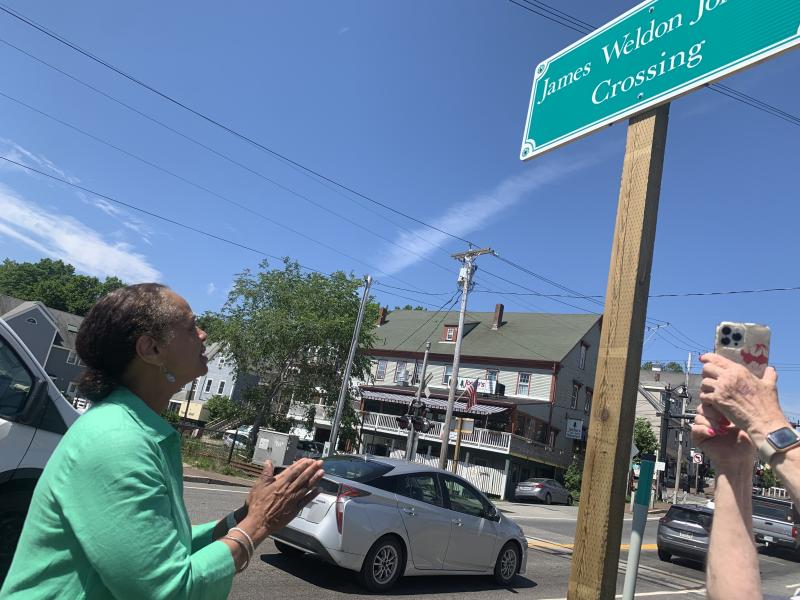 State Sen. Rachel Talbot Ross makes a praying motion and later motioned kisses and applause toward the sign on the southbound side of Route One. SUSAN JOHNS/Wiscasset Newspaper Ceremony
