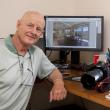 Rubicam in front of a photo of a home's interior that he took.