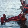 Members of the Wiscasset Fire Department, clad in bright red Gumby suits, conduct a water rescue training exercise on the town's waterfront August 22. JOHN MAGUIRE/Wiscasset Newspaper