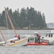 Shipyard workers, Coast Guard personnel and Boothbay Harbor's Harbor Master secured the sailboat which half sunk at its mooring Tuesday afternoon. KEVIN BURNHAM/Boothbay Register