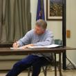 Wiscasset Withdrawal member Tim Merry signs the letter to the Department of Education requesting an extension for the withdrawal agreement, which is currently being prepared to withdraw from RSU12. CHARLOTTE BOYNTON/Wiscasset Newspaper