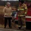 Alna firefighter Jeff Averill, right, has some coffee that Kitty Lipp brought out to emergency workers at the scene. SUSAN JOHNS/Wiscasset Newspaper 