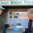 SVCA president John Atwood presents Roy Farmer with a “By a Maine River” book as a token of thanks for his years of service to the association. Courtesy of Sheepscot Valley Conservation Association