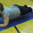  Patti Jo Averill holds a plank position during a “punishment” workout March 11. KATHY ONORATO/Wiscasset Newspaper