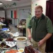 Lincoln County EMA/Communications Assistant Director Casey Stevens carves the ham. jOHN MAGUIRE/Wiscasset Newspaper