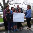 Below: From left to right, Cindy Collamore, Kadan Field, Carole Drury, Lily Souza, Olivia Peaslee, Roger Whitney and Karen Parker accepting the check on behalf of the Midcoast Hunger Prevention Program. SUSAN JOHNS/Wiscasset Newspaper