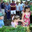 Cutting the beribboned garland at Saturday’s grand reopening of the shorefront Fairy House Village are twins Ronan and Maeve Cullina (age 5) and, at right, Brooklyn Cone (8-1/2). Stone “ruins” and other imaginative structures by Joe Norton add a touch of magic to the Village where visitors at the celebration sprinkled fairy dust, conjured up elaborate fairy houses and made cupcakes disappear. Courtesy of Barbara Freeman