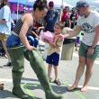 Wiscasset’s Corbin and Lucy Flores-Lichtinger and son Gideon, 7, take part in a relay at Wormfest in Wiscasset June 8. SUSAN JOHNS/Wiscasset Newspaper 