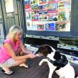 Philo, candidate for king of Wiscasset, offers a paw Aug. 30 to Laurie Winslow, a friend of his owner Cynthia Pappas. Signs in town declared local pets’ candidacies for offices real and not real. SUSAN JOHNS/Wiscasset Newspaper  