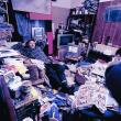 man relaxing in hoarder house