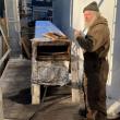 Tom Gerhard shows off a steam box used to make wooden planking pliable enough to put on the ship. FRITZ FREUDENBERGER/Boothbay Register