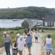 Visitors make their way up the hill on the island. File photo