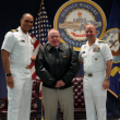 Capt. (ret) Floyston "Bud" Weeks, stands with Adm. Jim Kilby, Acting Chief of Naval Operations, and Capt. Joe Baggett, SWSC Commanding Officer, at his retirement ceremony at SWSC Newport, Naval Station Newport, R.I., July 18, 2025. John Goulette photo