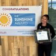 Jessica Gordon with her Sunshine Award and banner. Courtesy photo