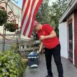 Red’s Eats employee Sandy Craig sweeps away leaves  at the internationally famous Wiscasset stand before it opens for the day Oct. 2. SUSAN JOHNS/Wiscasset Newspaper 