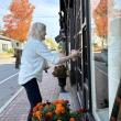 Surrounded by the fiery colors and reflections of the season, Ann Scanlan arrives at her Sylvan Gallery on Water Street, Wiscasset Friday morning, Oct. 2. SUSAN JOHNS/Wiscasset Newspaper 