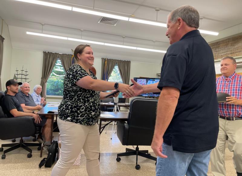 Selectboard chair Sarah Whitfield presents John Merry a plaque to recognize his 50 years of service to the town. FRITZ FREUDENBERGER/Boothbay Register
