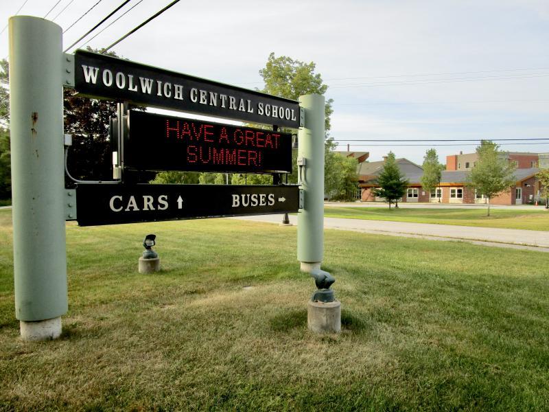 The sign at the entrance of the Woolwich Central School directs motorist to separate lanes for cars and buses. PHIL DI VECE/Wiscasset Newspaper