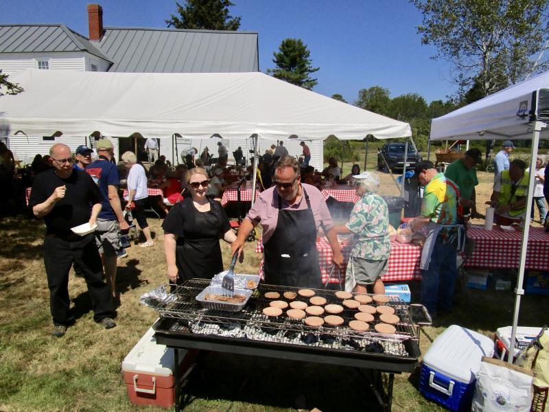 Woolwich held its annual community picnic this past Saturday featuring free grilled hotdogs, hamburgers, soft drinks and tours of the farm house museum. Live music for the event was provided by the Montsweagers. That’s Selectman Jason Shaw and his wife Vanessa manning the grill. PHIL DI VECE/Wiscasset Newspaper 