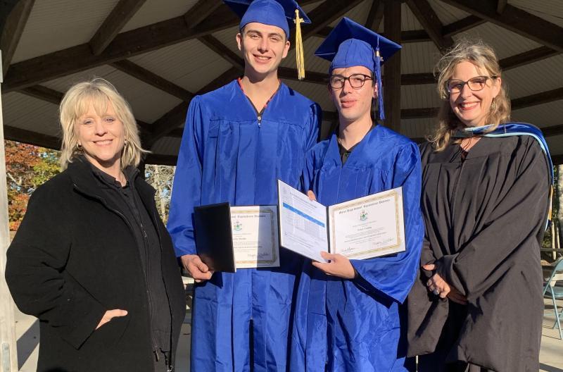 New graduates Colin Mettle, second from left, and Peter Young, second from right, display their diplomas Oct. 22 during the Boothbay/Wiscasset Adult Education ceremony held at Barrett's Park. Also pictured, adult education teacher Margit Ahlin, left, and Adult Education Director Raye Leonard. BILL PEARSON/Boothbay Register   New grads