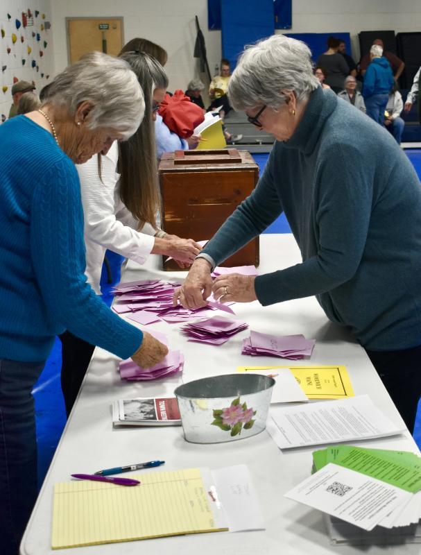 Ballot clerks count ballots at the annual town meeting on a motion concerning library funding.  PHIL DI VECE/Wiscasset Newspaper