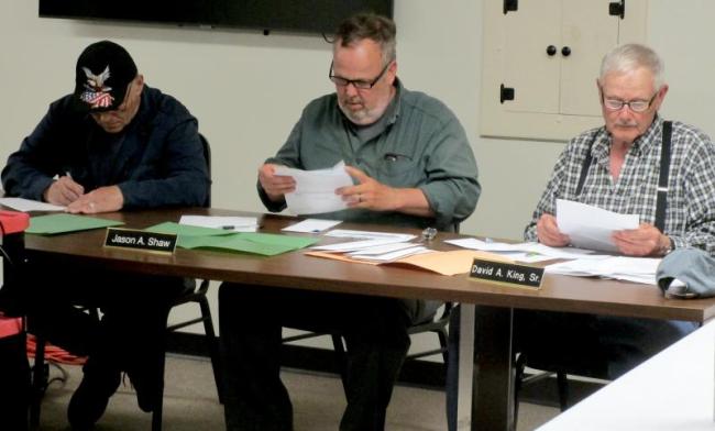 Selectmen opening bids for Woolwich's winter road maintenance contracts. PHIL DI VECE/Wiscasset Newspaper