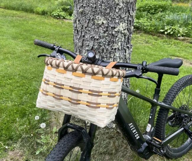 Workshop participants may choose to weave either a bike basket like this one, or a gathering basket with a wooden swing handle. Courtesy of Coastal Rivers
