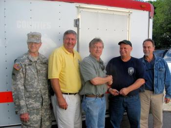 From left: Army National Guard Sgt. Brad Kelso, 11th Civil Support Team (Weapons of Mass Destruction) in Waterville; Ken Desmond, Training & Operations Office at Lincoln County Emergency Management Agency; Lincoln County Commissioner Sheridan Bond; Newcastle Fire Chief Clayton Huntley; and Lincoln County Emergency Management Agency interim Director Tod Hartung. Below, it takes two people to inflate the Hazmat (hazardous materials) Decontamination tent. Total setup time: 2 minutes. Courtesy of LCEMA