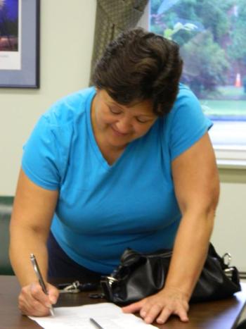 Wiscasset Selectman Pam Dunning Pam Dunning, signs the warrant for the special town meeting Sept. 11, following an early morning meeting July 27. CHARLOTTE BOYNTON/Wiscasset Newspaper