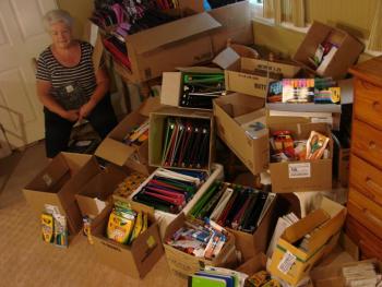 Shown partly surrounded by donated school supplies, Sue Burge is determined to help all students at three area elementary schools start the next school year right. SUSAN JOHNS/Wiscasset Newspaper