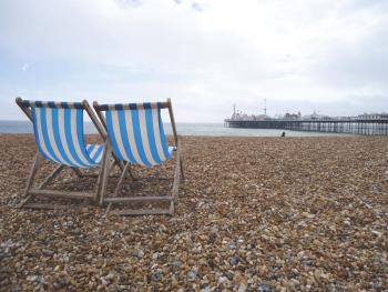 “The View From Brighton” by Devin Mellor features a pair beach chairs facing Brighton Pier in the United Kingdom. 