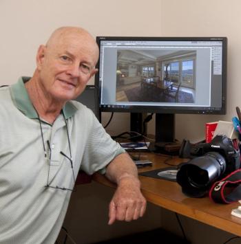 Rubicam in front of a photo of a home's interior that he took. Rubicam in front of a photo of a home's interior that he took.