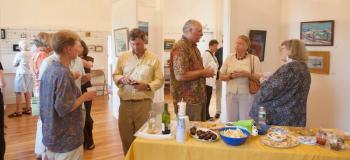 Art patrons enjoy some refreshments and art at the Maine Art Gallery's Marine Art exhibit on opening night.