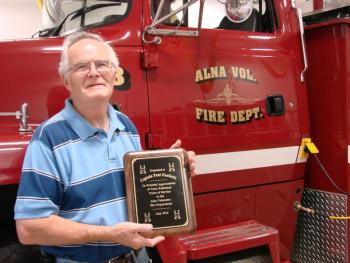 Alna Fire Captain Paul Ouelette holds the plaque the department recently gave him for his service. Ouellette and his wife of 50 years Jackie Ouellette are moving to North Carolina. SUSAN JOHNS/Wiscasset Newspaper