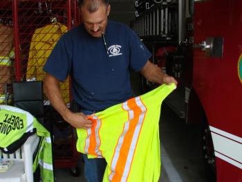 Edgecomb Fire Capt. James Fisk puts away reflective gear back at the town's new fire station, after helping clean up a small oil spill August 17. SUSAN JOHNS/Wiscasset Newspaper
