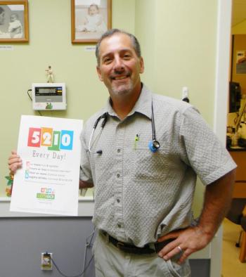 Dr. Steven Feder is one of 200 pediatricians in Maine to receive an award for a childhood obesity prevention program, among other initiatives. The 5-2-1-0 program is so popular that many states have sought to use the campaign. Feder stands in his office at the John F. Andrews Medical Arts building in Boothbay Harbor, holding one of the catchy posters distributed throughout the nation to promote healthy families. DIANE RANDLETT/Boothbay Register Dr. Steven Feder is one of 200 pediatricians in Maine to receive an award for a childhood obesity prevention program, among other initiatives. The 5-2-1-0 program is so popular that many states have sought to use the campaign. Feder stands in his office at the John F. Andrews Medical Arts building in Boothbay Harbor, holding one of the catchy posters distributed throughout the nation to promote healthy families. DIANE RANDLETT/Boothbay Register