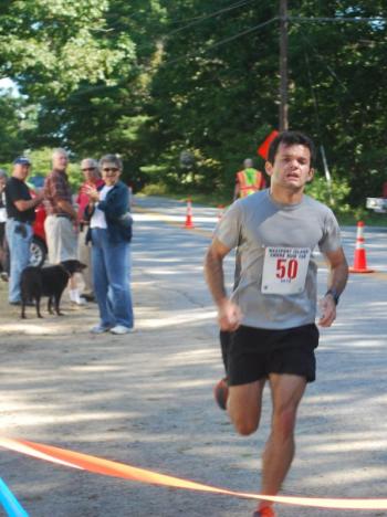 Below, Winthrop's Wes Danforth finishes first with a time of 39.05 in Maine’s Best Little 10K Road Race on Westport Island on August 19. 