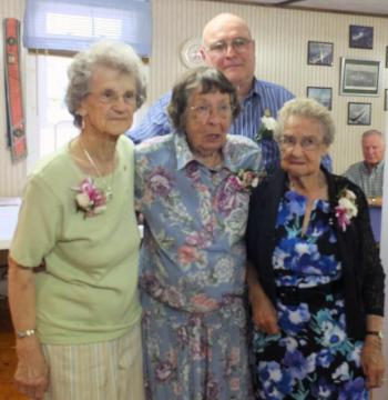 Longtime woolwich grange members receive membership awards. From left, Marion Grover Bailey, Charlotte Waltz Leeman Sutter and Grace Smith receive their awards from Woolwich Grange Master John Hauck, standing in the back. KATHY ONORATO/Wiscasset Newspaper 