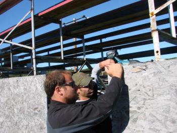 r. of West Gardiner applies paint. SUSAN JOHNS/Wiscasset Newspaper 