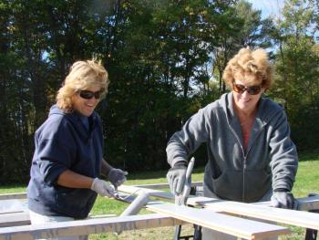 Wendy Caron, left, of Boothbay Harbor and Michelle Peele have fun working at the site of a riverside barn, at Peele's Marianmade Farm in Wiscasset. SUSAN JOHNS/Wiscasset Newspaper Wendy Caron, left, of Boothbay Harbor and Michelle Peele have fun working at the site of a riverside barn, at Peele's Marianmade Farm in Wiscasset. SUSAN JOHNS/Wiscasset Newspaper
