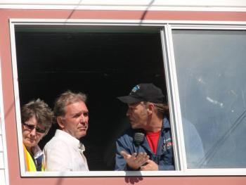 Speedway owners Vanessa Jordan, left, and Richard Jordan hear from race organizer Dale Chadbourne, far right, of Woolwich as the three meet with drivers gathered below the window. SUSAN JOHNS/Wiscasset Newspaper 