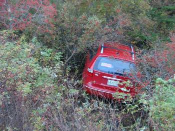 A car sits in the brush off Edgecomb's Route 27 October 18 after it collided with a truck. SUSAN JOHNS/Wiscasset Newspaper