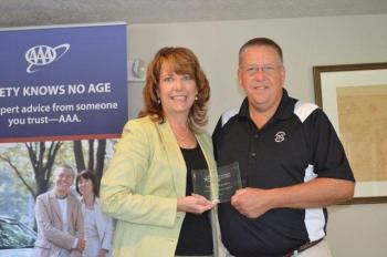 State Director Kim Gore presents the Champion of Children award to Lincoln County Sheriff Todd Brackett in recognition for his commitment and work to keep Maine's children safe and out of crime. 