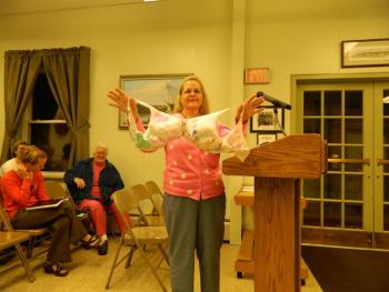 National breast cancer awareness representative Debbie Jones holds up one of many bras that will be hung in the town office meeting room. CHARLOTTE BOYNTON/Wiscasset Newspaper