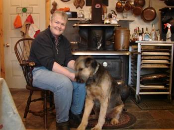 Kilkelly and Estee, who herds the livestock, enjoy a moment by the wood stove.